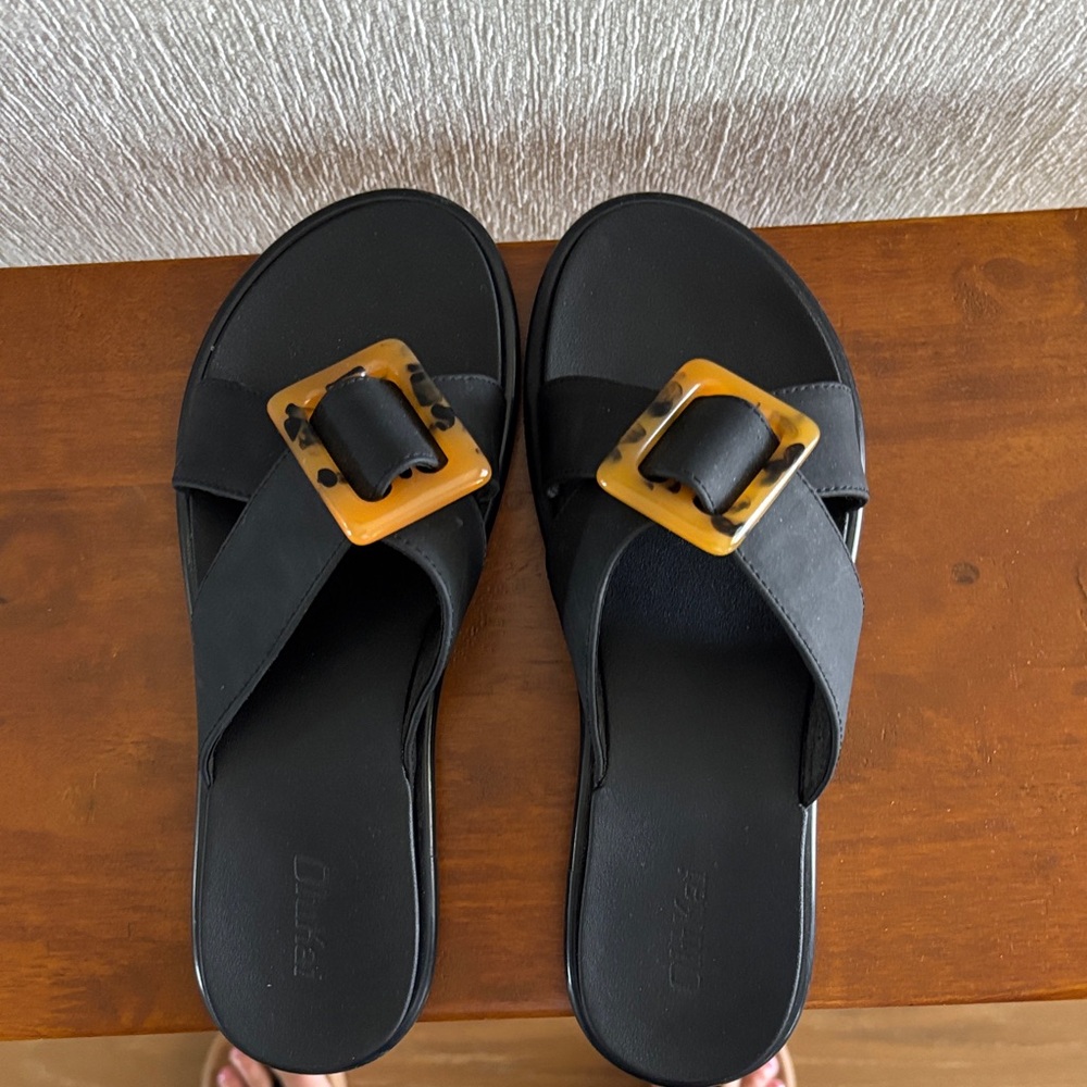 OluKai Black Slide Sandals with Tortoiseshell Buckle Accent